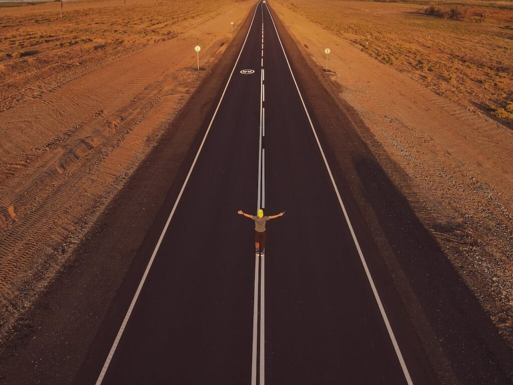 A person standing at a road or career crossroads
