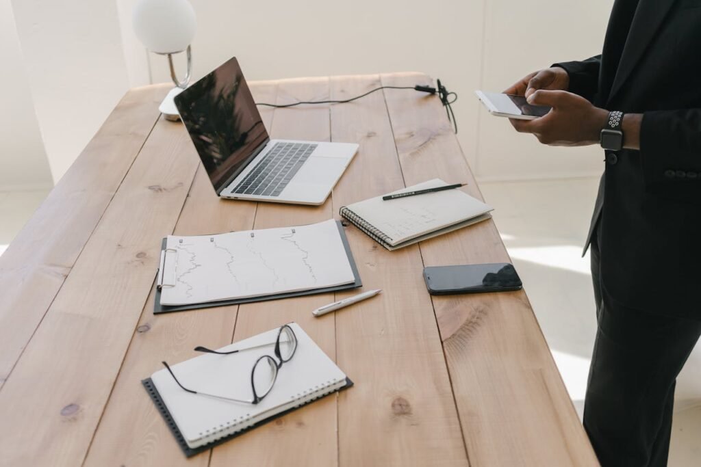 standing at a desk with a notebook open