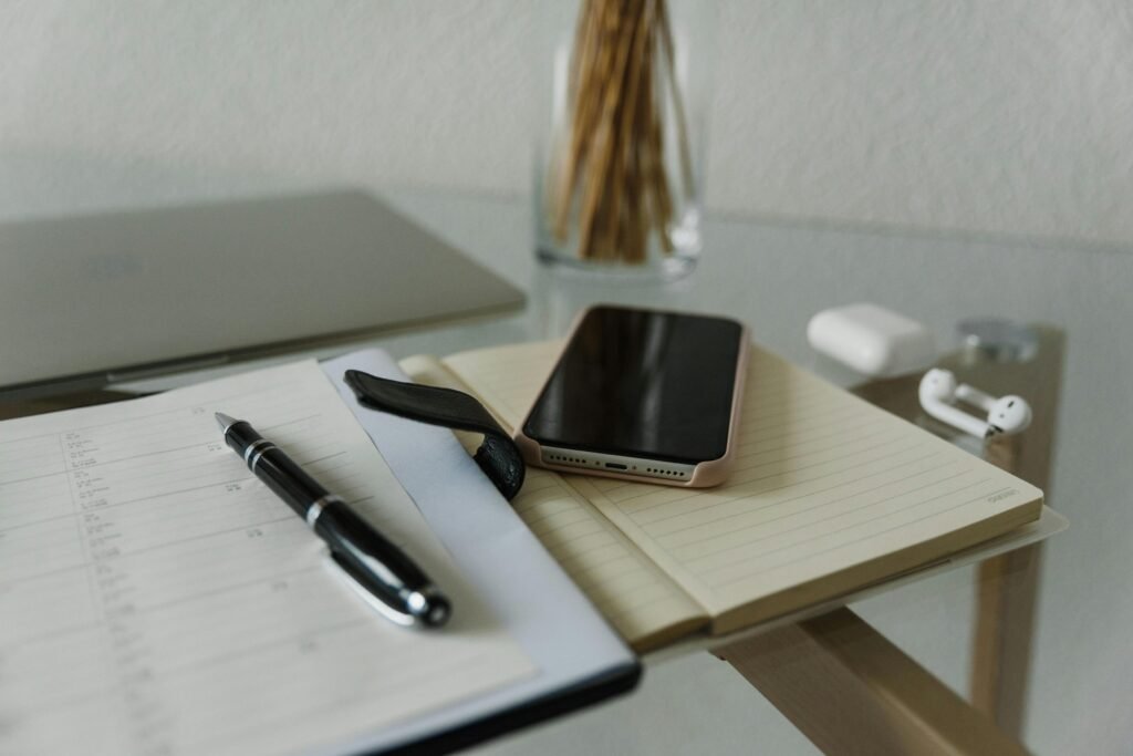 A simple weekly calendar with flexible time blocks, a notebook, and a laptop on a clean desk