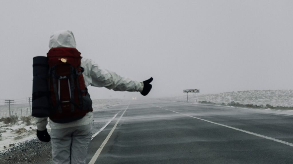 A professional standing at a clear road or pathway with signs pointing forward