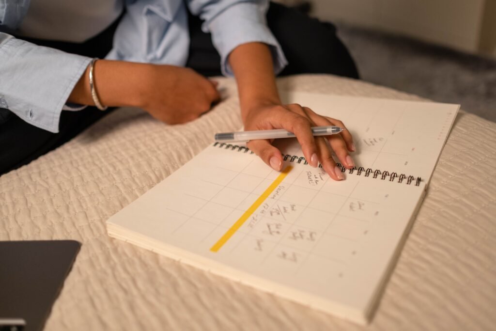 A clean desk with a notebook, task list, calendar, and pen