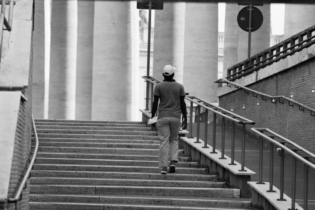 A professional walking on a long road or climbing stairs slowly