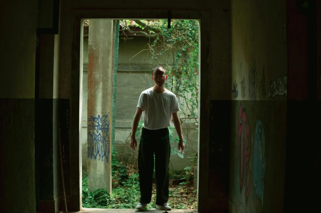 standing confidently at an open doorway