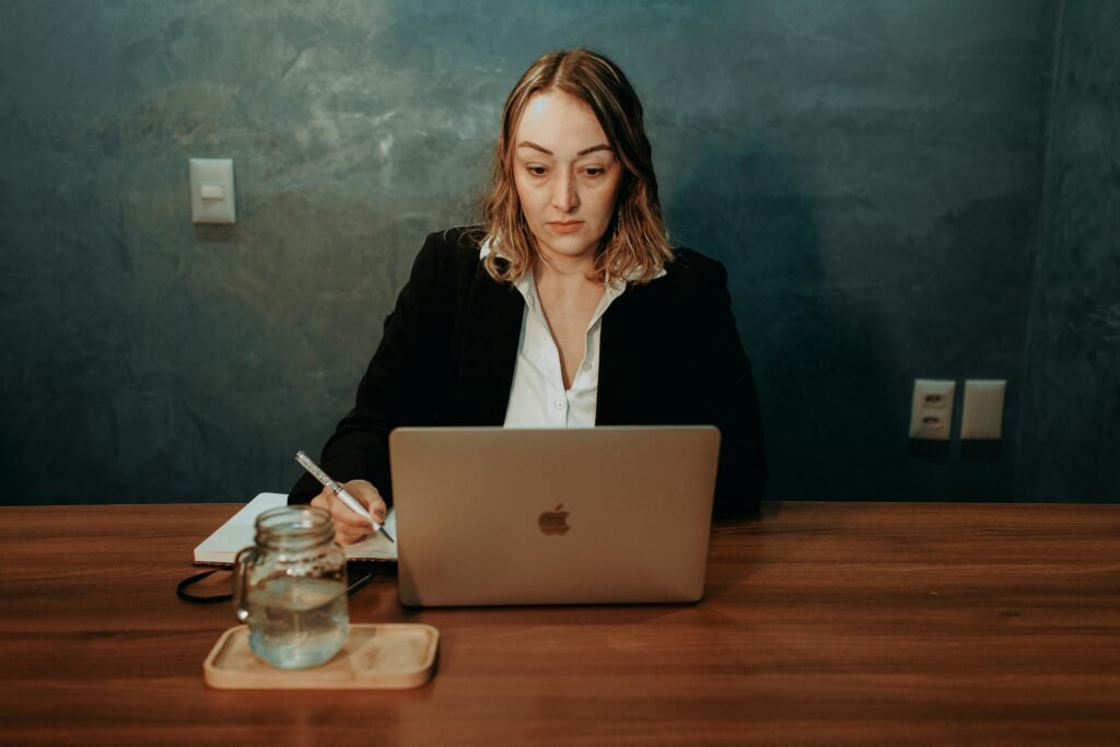 A person sitting at a clean desk with a notebook showing one simple priority