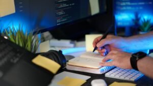 A person planning the week in a notebook or digital calendar beside a laptop, with goal checklists and time blocks