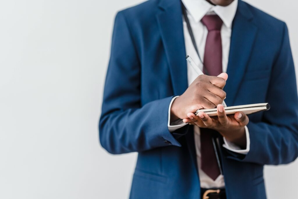 A professional writing notes in a workplace journal or reviewing lessons learned from different jobs