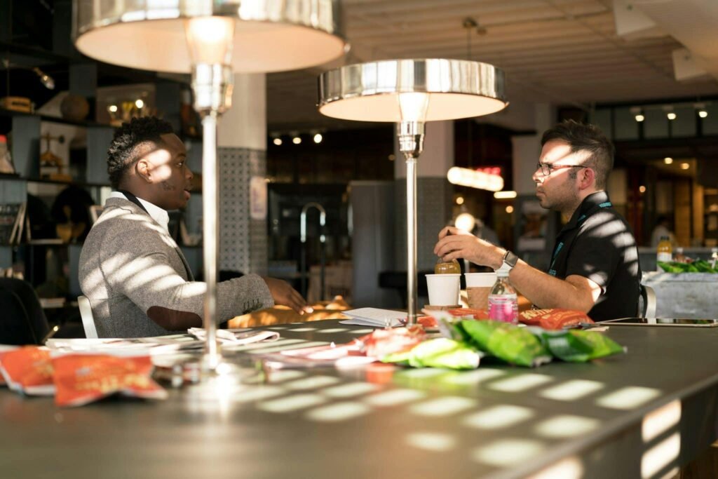 A professional conversation between two people in a calm office or café setting