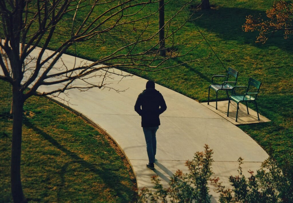 A person walking calmly on their own path while other paths appear in the background