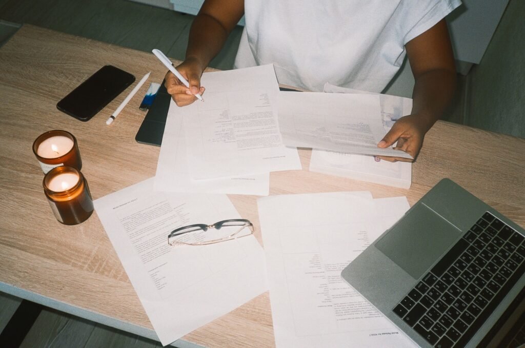 A person sitting at a desk with many papers