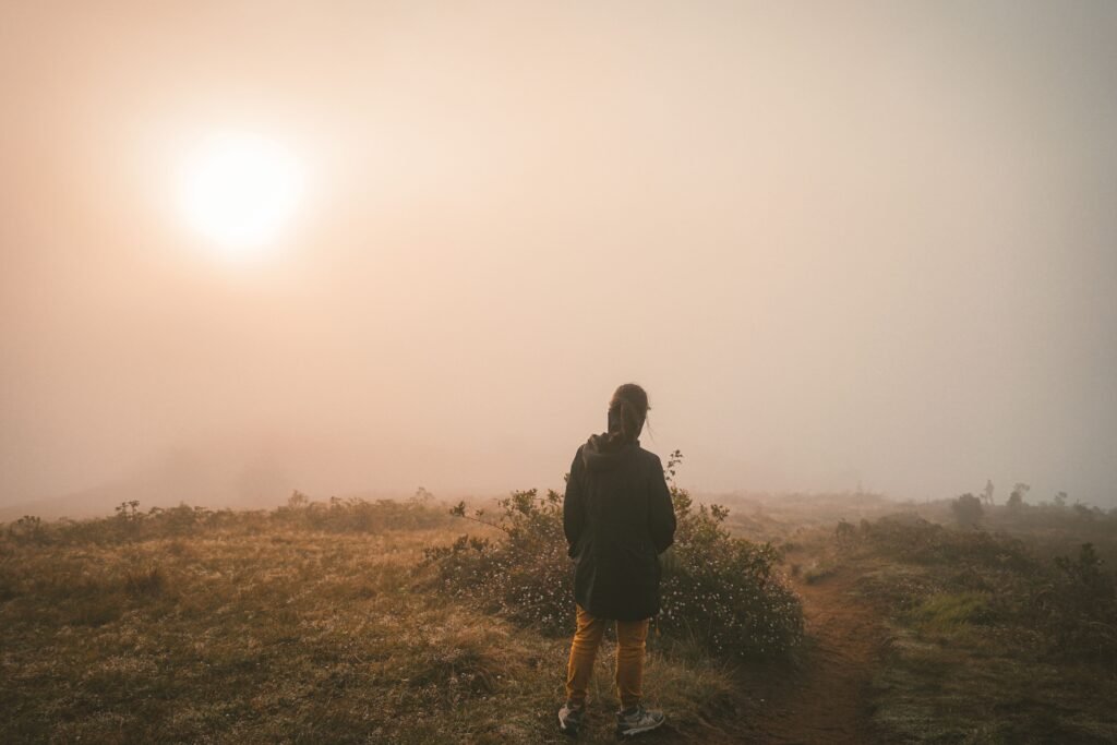 A person standing at sunrise on a quiet road