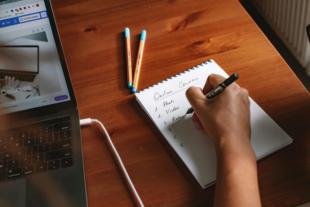 A person sitting at a desk with a long task list but highlighting only three important priorities