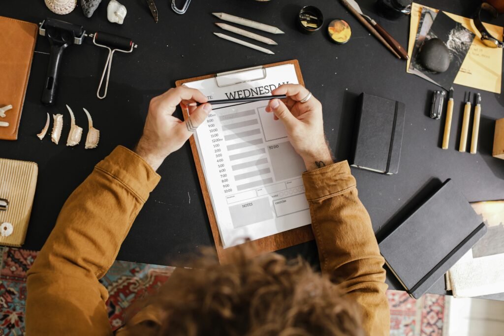 A calm workspace with a weekly planner, clock, notebook, and highlighted priority list