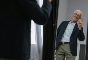 A person standing confidently in front of a mirror with a calm expression