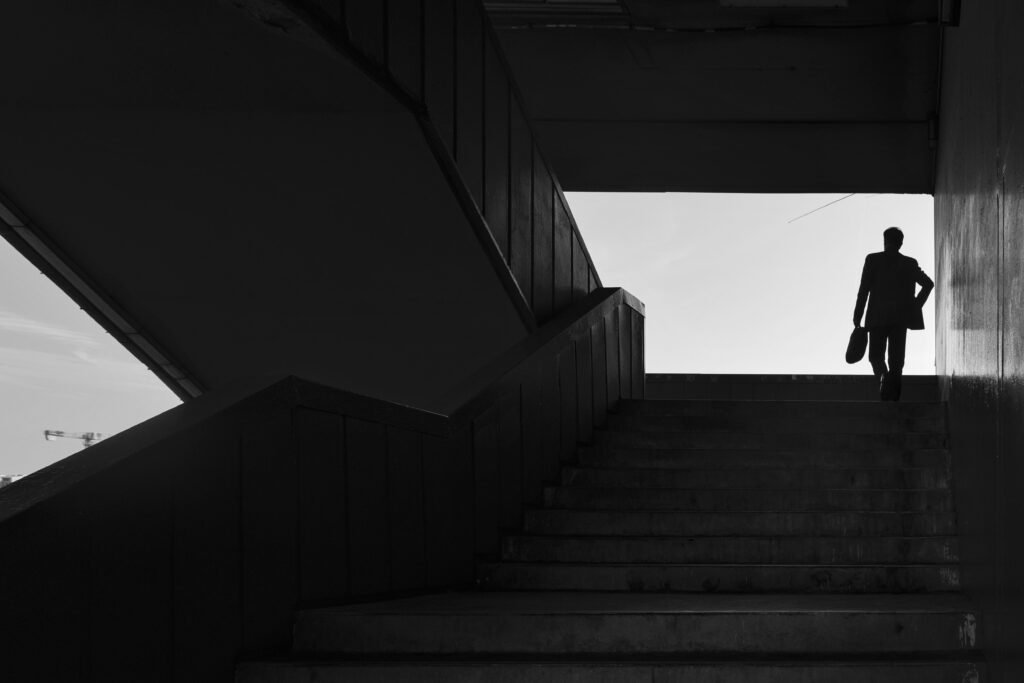 A professional walking up a staircase or moving forward on a clear path
