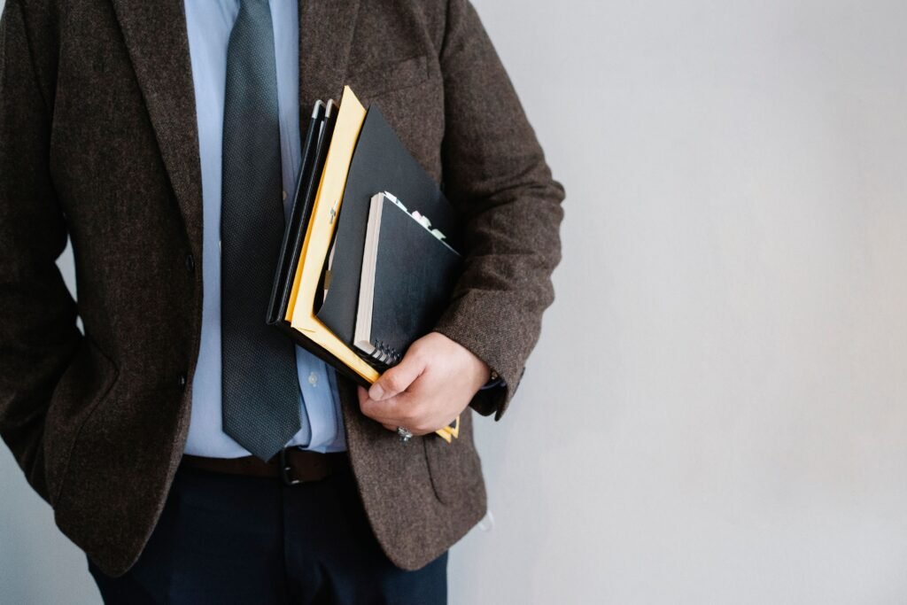 A professional standing at a crossroads or looking at a notebook with career options