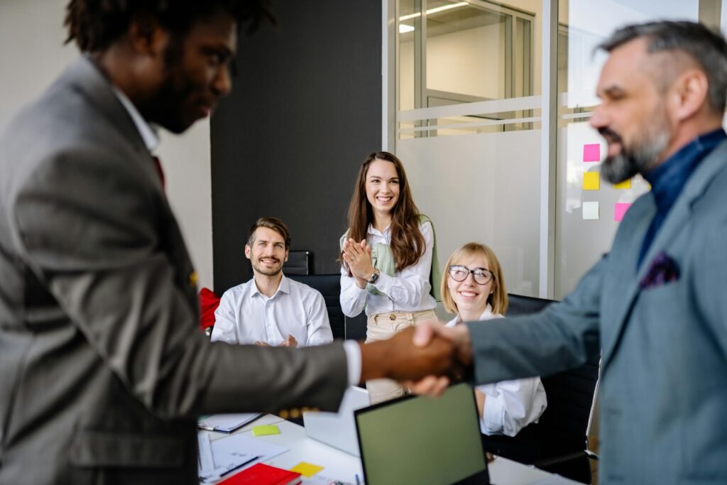 A confident professional shaking hands with a colleague